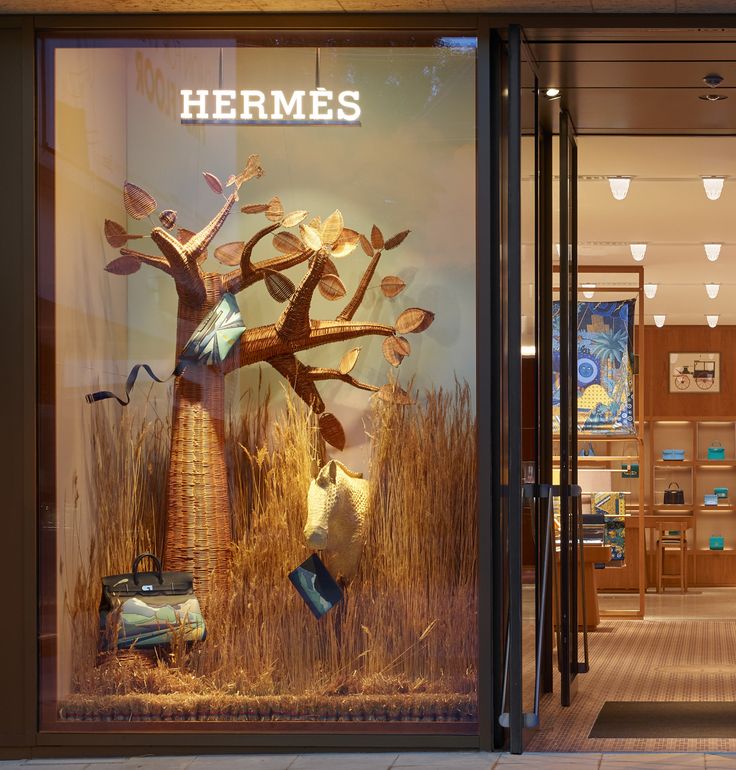 a store front with an advertisement for hermes on the window and in it's display case