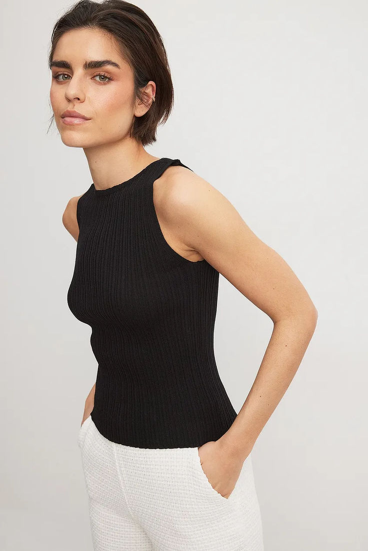 Fine Knitted Sleeveless Top Chic Ribbed Crew Neck Tank Top, Black Ribbed Stretch Sweater Vest, Black Stretch Ribbed Sweater Vest, Black Knit Crew Neck Tank Top, Elegant Stretch Crew Neck Tank Top, Elegant Crew Neck Stretch Tank Top, Elegant Stretch Tank Top With Crew Neck, Chic Black Tank Top With Ribbed Neckline, Black Ribbed Sleeveless Knit Top