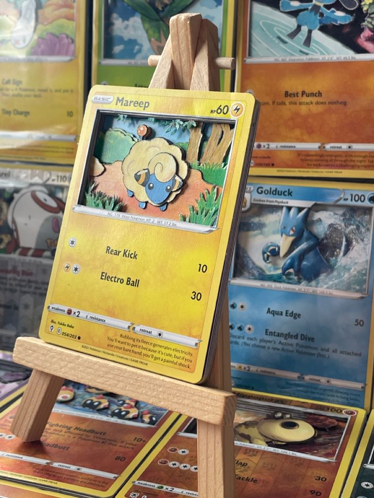 a wooden easel with some pokemon cards on display in front of other card boards