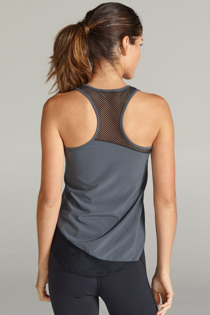 A lightweight, moisture-wicking workout tank that's perfect for your sweatiest workouts. Curved hemlines and strategic mesh placements. GRAPHITE is the new Fall "IT" color! Pair it with the Tatiana Capri for the complete look. By CHICHI Active. - Machine wash cold with like colors/gentle cycle. - Do not bleach/hang dry. - Made in the USA. Gray Racerback Activewear For Summer, Gray Racerback Summer Activewear, Sleeveless Nylon Activewear For Yoga, Athletic Fit Mesh Back Tank Top For Sportswear, Sportswear Racerback Tank Top With Mesh Back, Athletic Fit Activewear Tank With Mesh Back, Athletic Fit Tank Activewear With Mesh Back, Sports Activewear Tank With Mesh Back, Sports Mesh Back Tank Top