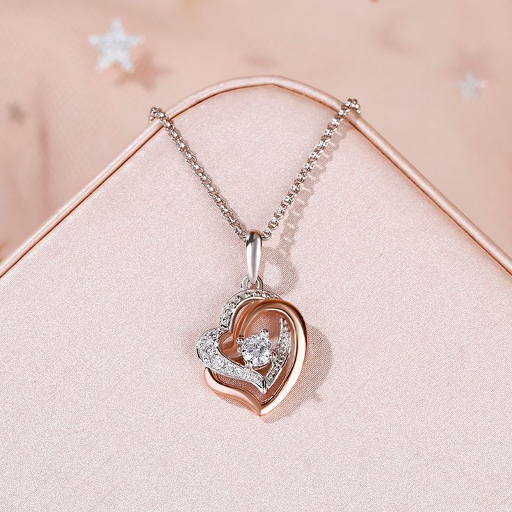 Simple and classic, this heart necklace makes an adorable gift for loved one. Heart is one of the most popular motifs in jewelry. It's always related with love. Crafted in sterling silver, it features two open heart-shaped frames centered with a bright round cut stone. Lending sparkle, the heart outline adorned with shimmering round stones. This fashion and sweet necklace keeps your heart close to hers at all times.Carat Weight: 0.419 ctStone Size: 1,1.8,1.5,3.5 mmStone Type: Jeulia® StoneNumber Elegant Rose Gold Necklace For Mom, Elegant Rose Gold Necklace As Gift For Mom, Valentine's Day Heart Pendant Clavicle Chain, Valentine's Day Clavicle Chain With Heart Pendant, Rose Gold Heart Pendant Necklace For Her, Rose Gold Heart Pendant Necklace Gift For Her, Rose Gold Heart Jewelry For Valentine's Day, Rose Gold Heart Pendant Necklace, Heart Cut Necklaces With Heart Detail For Anniversary