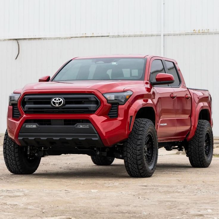 a red truck parked in front of a building