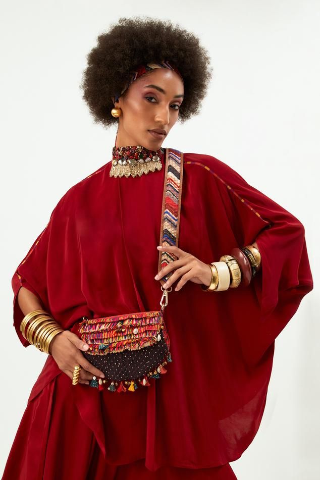 Sindoor kaftan top with bead embellished neck and tie-up. Paired with flared trouser.
Components: 2
Pattern: Embellished
Type Of Work: Bead
Neckline: Band collar
Sleeve Type: Kaftan sleeves
Fabric: Natural crepe
Color: Red
Other Details: 
Tie-up
Length:
Top: 29 Inches
Pant: 44-48 Inches
Note: The bag held by the model is not for sale
Occasion: Wedding - Aza Fashions Bollywood Style Festival Kaftan With Traditional Drape, Embellished Tunic Kaftan For Festival, Red Traditional Drape Kaftan For Party, Bohemian Hand Embellished Kaftan For Parties, Bohemian Kaftan For Navratri Party, Bohemian Embellished Kaftan With Traditional Drape, Festival Embellished Tunic Kaftan, Red Bohemian Kaftan For Designer Wear, Red Bohemian Designer Kaftan