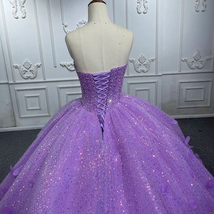 Make a dazzling entrance in this Quinceanera Dress that combines sparkling glamour with timeless elegance. This A-line gown is crafted from luxurious purple sequin fabric and features a sweetheart neckline that flatters the bust and creates a graceful, feminine silhouette. The intricate applique detailing and shimmering sequins embellish the bodice, adding a touch of sparkle and sophistication that will catch the light from every angle. The sweep train adds a romantic flow to the design, creatin Strapless Sequin Ball Gown For Prom Season, Tulle Quinceanera Dress With Sweetheart Neckline For Banquet, Quinceanera Tulle Dress With Sweetheart Neckline For Banquet, Sweetheart Neckline Tulle Quinceanera Dress For Banquets, Purple Sequin Dress For Debutante Ball, Princess Quinceanera Dress With Sweetheart Neckline For Banquet, Sequin Fitted Quinceanera Dress For Debutante Ball, Fitted Sequined Quinceanera Dress With Sweetheart Neckline, Princess Style Strapless Ball Gown For Party