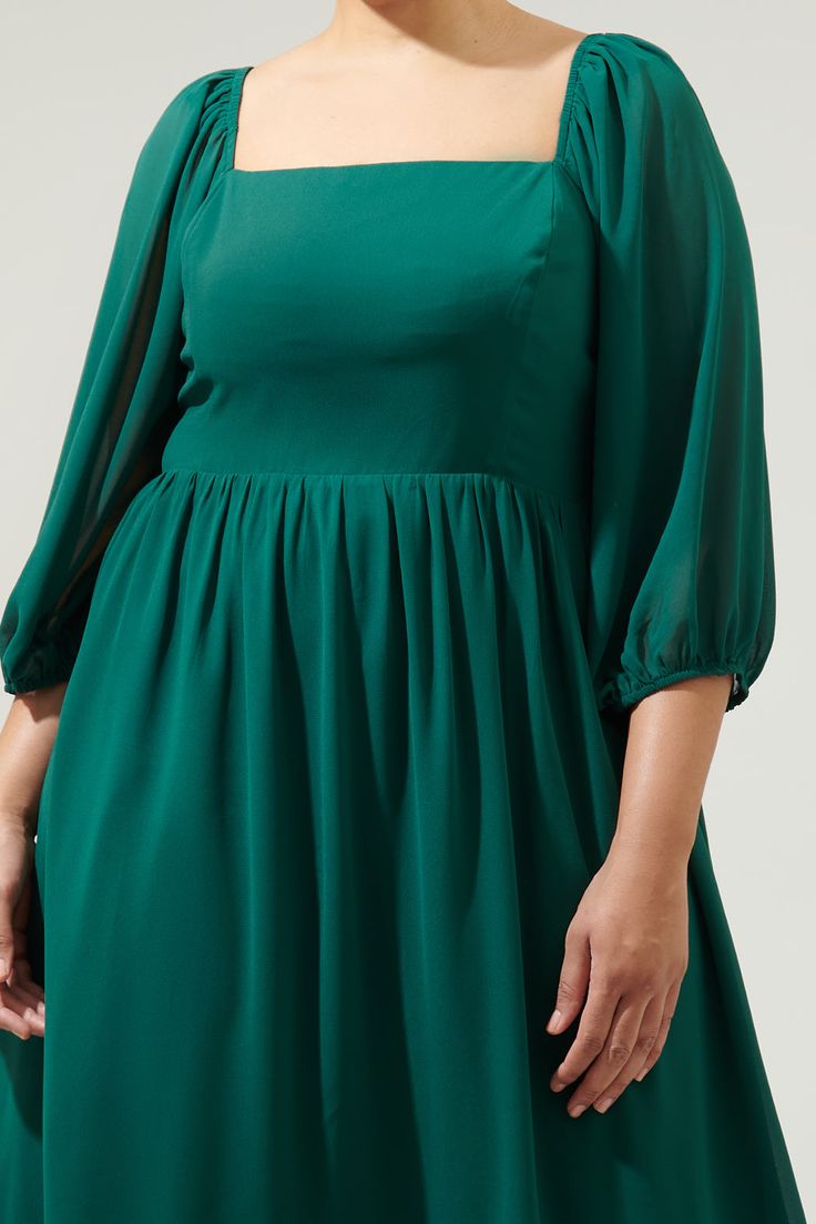 Get all dressed up in this flowy chiffon midi dress. An elegant style that features a square neckline framed by long, balloon sleeves. A flattering bodice comfortably holds everything in by a smocked back. A flowy midi skirt finishes off the look and can be paired with strappy heels.- Chiffon- Zipper- Smocked back- Lined- Comes in 2 colorsSize + Fit - Model is 5'9" and wearing size 2X- Measurements taken from size 2X - Chest: 23 1/2"- Length: 44 3/8" Fabric Self: 98% Polyester 2% Lurex Lining: 9 Emerald Midi Dress, Flowy Square Neck Formal Dress, Formal Flowy Square Neck Dress, Formal Flowy Dress With Square Neck, Midi Dress With Balloon Sleeves, Billowy Square Neck Dress For Party, Billowy Square Neck Party Dress, Flowy Chiffon Square Neck Dress, Flowy Puff Sleeve Dress With Square Neck For Party