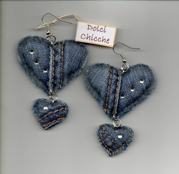 two denim heart shaped earrings hanging from hooks on a gray background with a sign that says dolcet chocchine