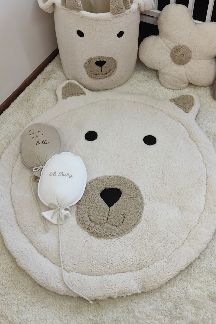 a teddy bear rug and other stuffed animals on the floor