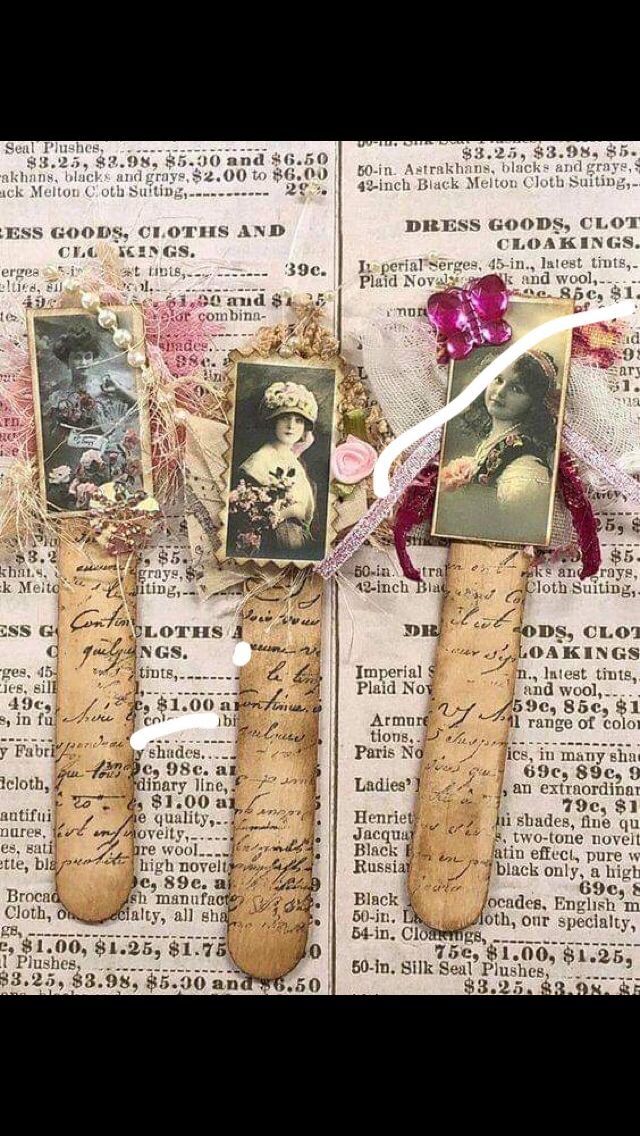 three old fashioned clothes pins with pictures on them sitting on top of an open book