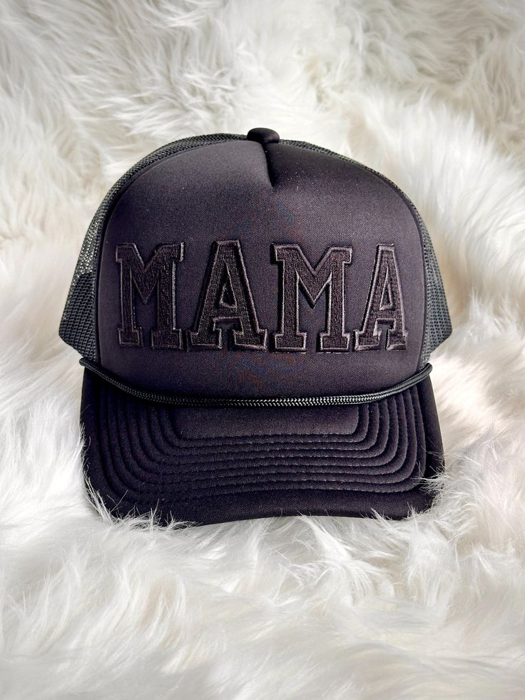 Show off your mama pride in style with this trendy trucker hat! Featuring bold embroidered letter patches spelling out "MAMA," this hat is the perfect mix of comfort and charm. The mesh back keeps you cool, while the adjustable snapback ensures a perfect fit for any head size. Whether you're running errands, spending time outdoors, or just adding a casual flair to your outfit, this "Mama" trucker hat is a fun and fashionable way to celebrate motherhood. Details: High-quality embroidered letter patches Breathable mesh back for comfort Adjustable snapback closure for a customized fit Stylish and durable design, perfect for everyday wear Ideal gift for moms, new moms, or mama-to-be Complete your casual look with this must-have accessory! Trendy Black Trucker Hat With Embroidered Logo, Black Snapback Hat With Letter Print And Curved Bill, Black Snapback Hat With Letter Embroidery, Adjustable Black Snapback Hat With Letter Print, Black Trucker Hat With Letter Embroidery, Black Adjustable Snapback Hat With Letter Print, Mom Trucker Hats, Black Snapback Trucker Hat With Letter Embroidery, Adjustable Black Trucker Hat With Letter Embroidery