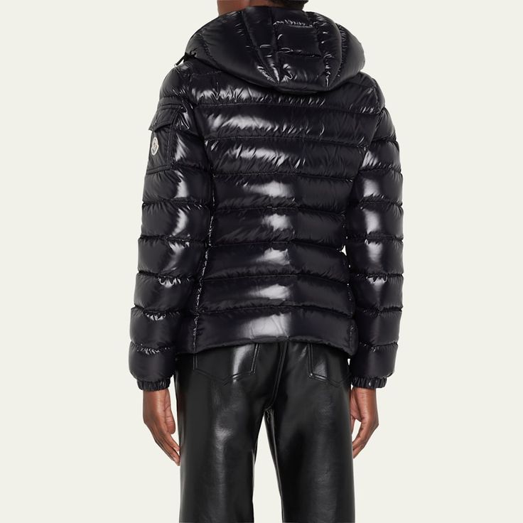 Moncler "Bady" jacket with detachable hood. Approx. length: 30" from shoulder to hem. Stand collar; two-way zipper. Long sleeves; left arm logo pocket. Angled zip pockets. Hip length hem. Fitted silhouette. 90/10 down/feather fill. Nylon shell. Nylon lining. Care instructions : Wash max. 30°C (mild process); Do not bleach; Do not tumble dry; Ironing maximum temperature 110°C (without steam); Dry cleaning in tetrachloroethene or with hydrocarbons (mild process); Professi... Luxury Down Puffer Jacket With Detachable Hood, Luxury Black Puffer Jacket With Double-lined Hood, Black Luxury Puffer Jacket With Double-lined Hood, Designer Fitted Puffer Jacket, Luxury Hooded Jacket With Double-lined Hood, Luxury Hooded Jacket With Padded Collar, Luxury Puffer Jacket With Padded Collar For Cold Weather, Designer Down Puffer Jacket With Detachable Hood, Luxury Hooded Jacket With Double-lined Hood For Fall