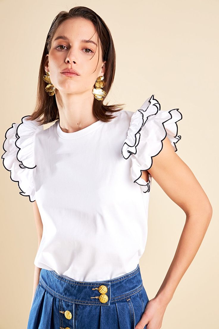 Elevate your wardrobe with our Merrow Stitch Ruffle Top. The rounded neckline adds a touch of femininity while the ruffle shoulder detail adds a playful and trendy touch. The contrast ruffle hem merrow stitch creates a unique and eye-catching look. With a regular length this top is perfect for both casual and dressy occasions. Made with high-quality materials this top is not only fashionable but also comfortable to wear. Perfect for standing out from the crowd our Merrow Stitch Ruffle Top is a m White Top With Ruffled Hem And Straps, White Tops With Ruffles And Ruffled Straps, White Tops With Ruffled Straps, White Tops With Ruffled Straps And Details, Chic Ruffled Crew Neck Tops, Chic Crew Neck Top With Ruffles, Chic Tops With Ruffle Hem And Ruffled Straps, Chic Tops With Ruffled Straps And Ruffle Hem, White Trendy Tops With Ruffled Straps