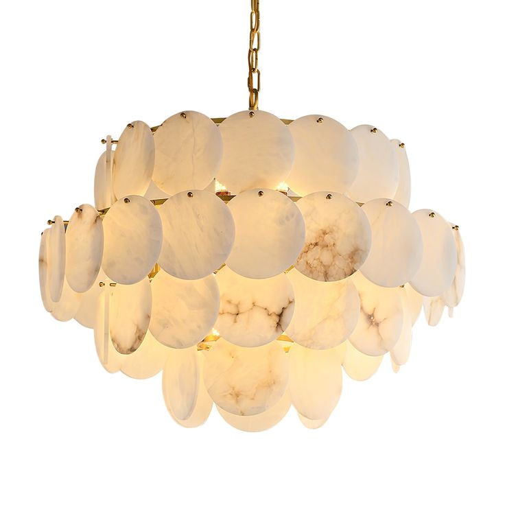 a white chandelier hanging from a gold chain with lights on each end and round shells in the middle