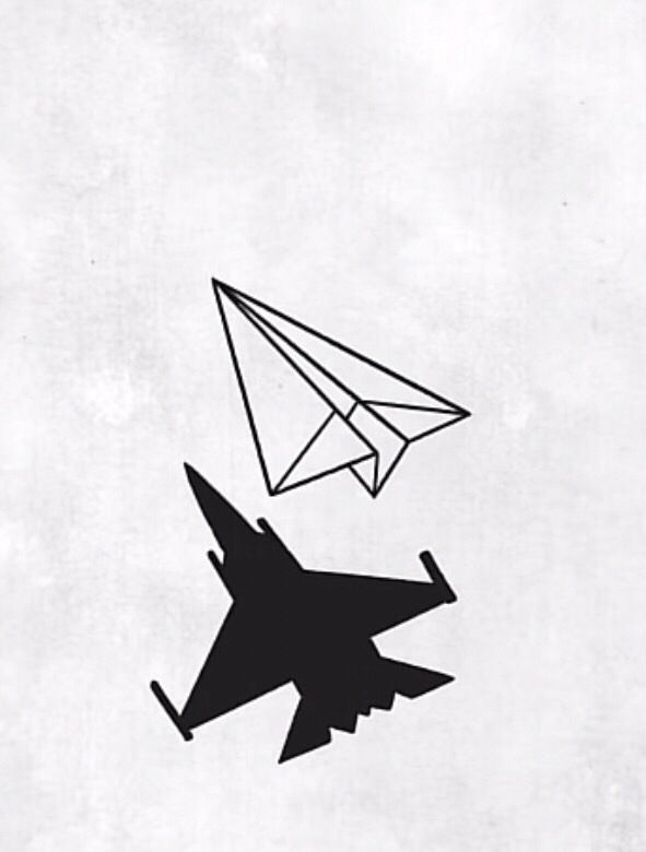 an airplane and a paper plane flying in the sky