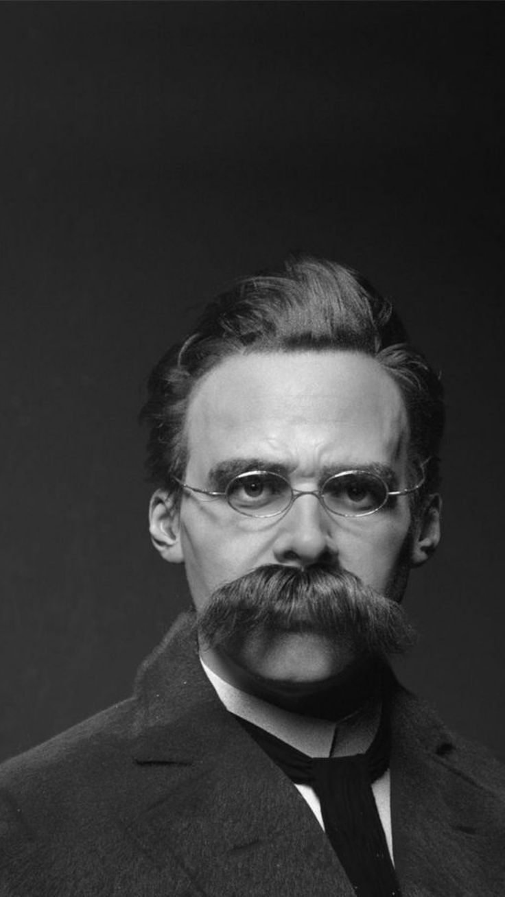 a man with glasses and a mustache wearing a suit