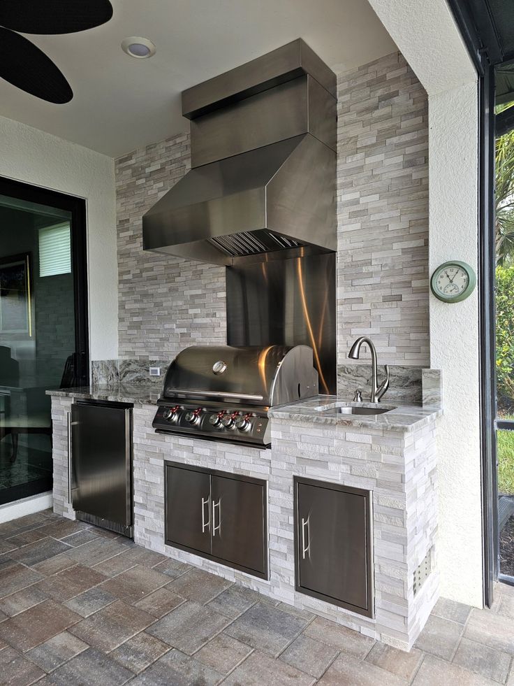 an outdoor kitchen with stainless steel appliances