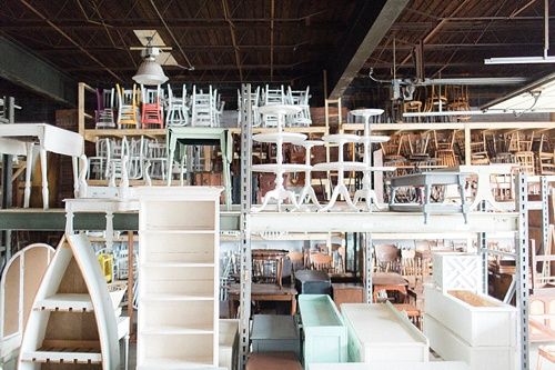 a room filled with lots of furniture and shelves