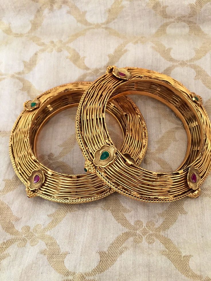 Simply a mark of royalty and elegance!! Handcrafted in brass with gold plating and fine quality Kundan stones. Set of 2 For wrist Size 2.4 Inner Diameter: 2.25 inches Not Openable The bangles are the same as shown in the pictures. We have only one piece in this color and design, hence you get what you see in the pictures. Gold-plated Jeweled Gold Bracelets, Gold-tone Metal Bangle For Wedding, Antique Gold Jeweled Jewelry For Weddings, Temple Jewelry Brass Bangle With Intricate Design, Ornate Brass Bangle For Wedding, Heavy Antique Gold Bracelets, Gold Jeweled Bangle For Celebration, Gold Brass Bangle With Intricate Design, Gold Jeweled Bracelets For Celebration