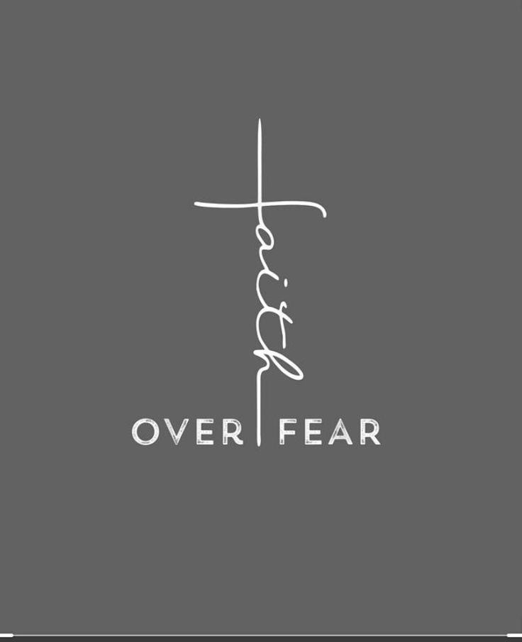 the word over fear written in white on a gray background with a cross above it