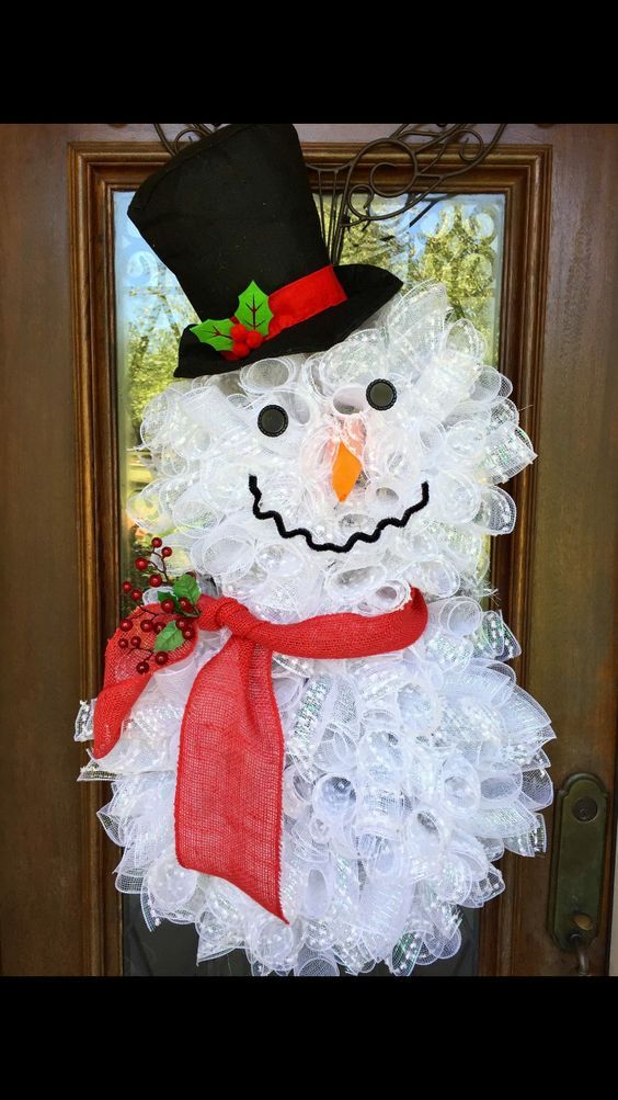 a snowman made out of plastic cups and burlocks on the front door