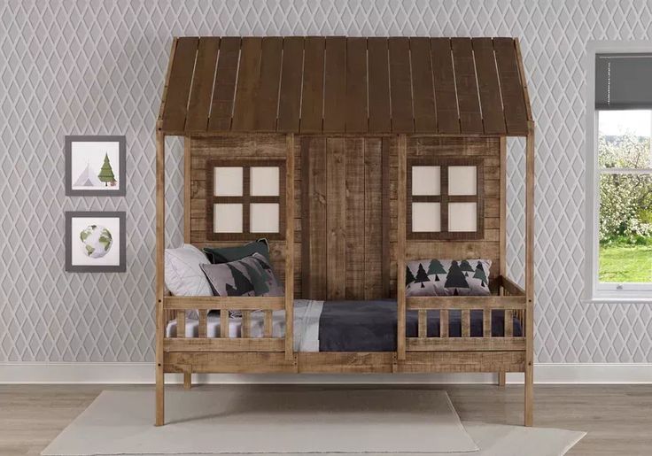 a wooden bed with a canopy over it in a room filled with pictures and decor