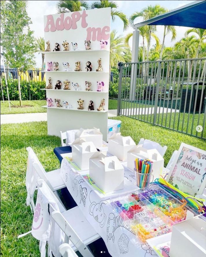 the table is set up outside with many items on it, including markers and pencils