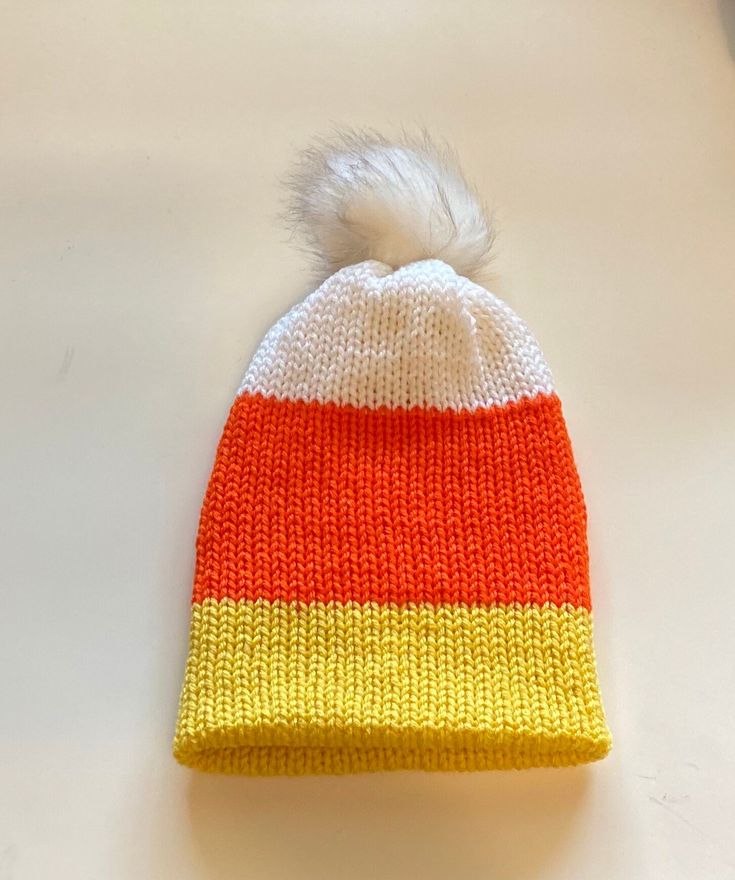 Candy Corn Beanie super cute toque candy corn stripes' version with WHITE Pom Pom #candycorn #candycornbeanie Playful White Beanie One Size Fits Most, Cute White Knitted Beanie, Cute White Knitted Hat, Playful White Beanie For Winter, White Beanie For Halloween, Crochet Candy Corn Hat Free Pattern, Handmade White Beanie One Size, Crochet Candy Corn Hat, Crocheted Candy Corn