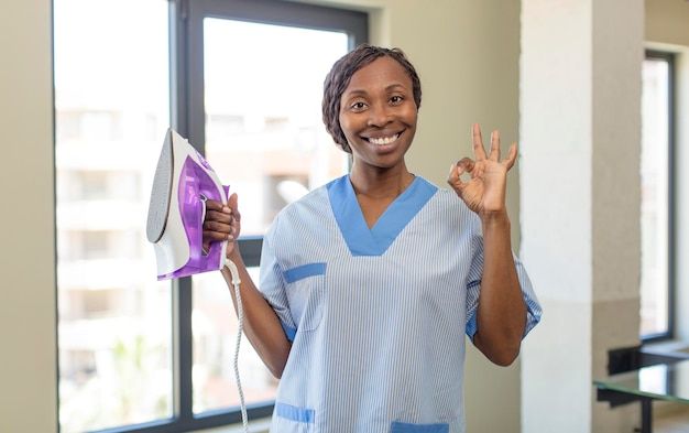 a woman in scrubs holding up her peace sign