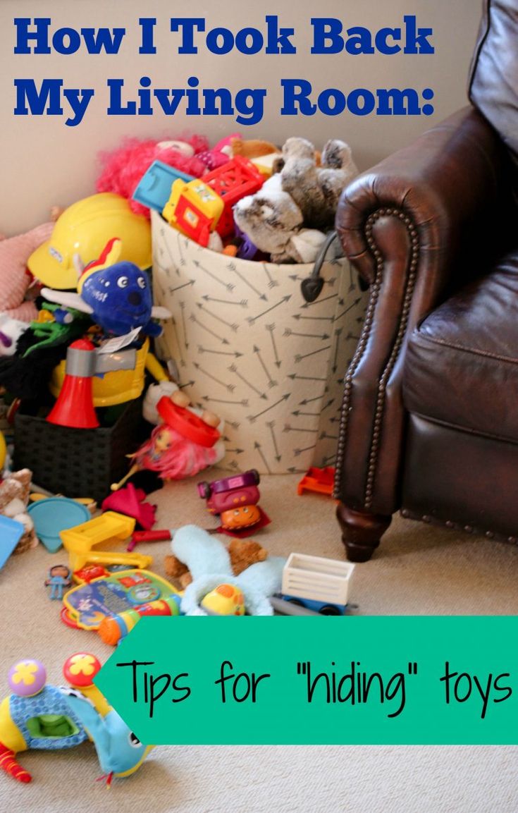 a pile of toys sitting on the floor in front of a chair with text overlay that reads how i took back my living room tips for hiding toys