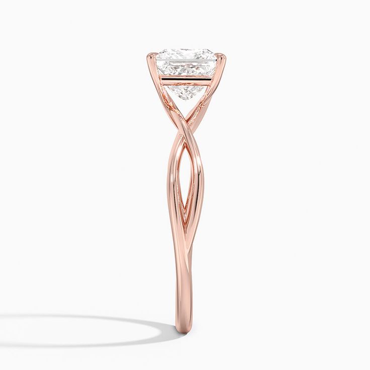 a rose gold engagement ring with a diamond in the center