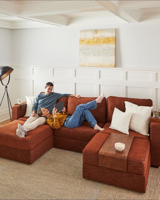 two people sitting on a couch in a living room with the caption lovesac