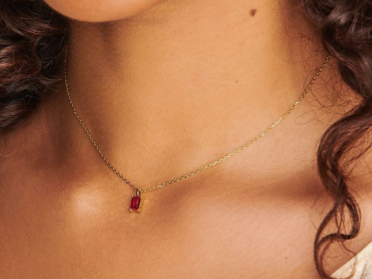 A dainty stone and delicate metallic chain are combined to create this Gold Pendant Necklace in brilliant ruby, your new favorite wear-anywhere accessory. The birthstone for the month of July is Ruby. This bold, saturated red gemstone helps the wearer overcome challenges and symbolizes courage and passion. Authentic ruby stone; Made of 14K gold-filled. Pendant size: 6mm x 4mm with 18" chain. Hypoallergenic, nickel, and lead-free. Tarnish resistant. Ideas to choose your Birthstone Necklace: Your Dainty Ruby Gemstone Birthstone Necklace, Dainty Red Birthstone Necklace, Red Dainty Birthstone Jewelry, Dainty Red Birthstone Jewelry, Red Birthstone Jewelry For Her, Red Ruby Gemstone Birthstone Necklace, Red Gemstone Birthstone Necklace Fine Jewelry, Red Birthstone Necklace With Lab-created Ruby, Fine Jewelry Red Gemstone Birthstone Necklace