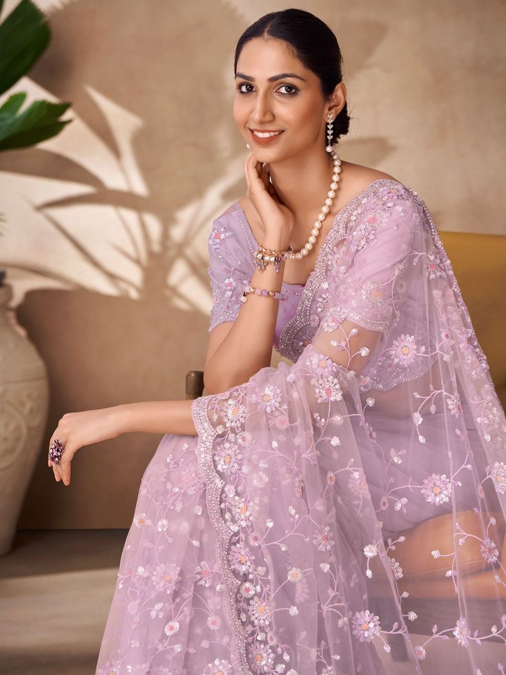 Upcoming parties, receptions, and any occasion with this beautifully designed lilac saree give the proper ethnic look to you. The "fascinating lilac thread work net party wear saree with blouse" is the perfect choice for those who want to make a statement with their attire.
Crafted in a stunning lilac color net fabric, this saree features intricate thread work, sequin work, and zarkan work that adds a touch of glamour and elegance to the overall look. The matching blouse also comes in a similar Lavender Saree Set For Party, Elegant Lavender Saree Set, Lavender Net Saree, Lavender Sequin Saree, Festive Lavender Semi-stitched Saree, Lilac Blouse, Reception Saree, Bridal Sari, Lehenga Crop Top