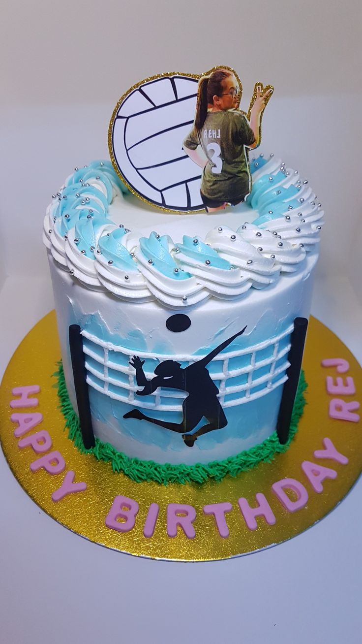 a birthday cake is decorated with an image of a woman jumping over a fence