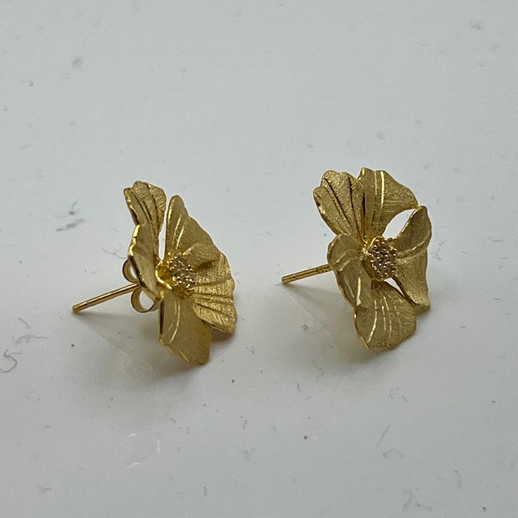 Inspired by the exquisite beauty of peony flowers, these studs exude elegance and sophistication. Crafted with meticulous detail and finished in radiant gold, they add a touch of floral glamour to any ensemble. Perfect for elevating your style with a timeless floral accent, these studs are sure to become a cherished addition to your collection. GV Peony w/CZ Luxury Yellow Gold Flower Earrings, Gold Plated Flower Charm Earrings For Wedding, Formal Yellow Gold Flower Earrings, Gold Elegant Flower Earrings With 3d Flowers, Elegant Gold Flower Earrings With 3d Details, Luxury Flower Earrings For Wedding, Gold Luxury Flower Earrings For Formal Occasions, Formal Rose Gold Flower Earrings, Luxury Gold Flower Earrings For Wedding