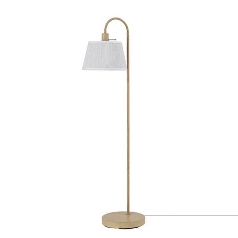 a floor lamp with a white shade on the top and a wooden base in front