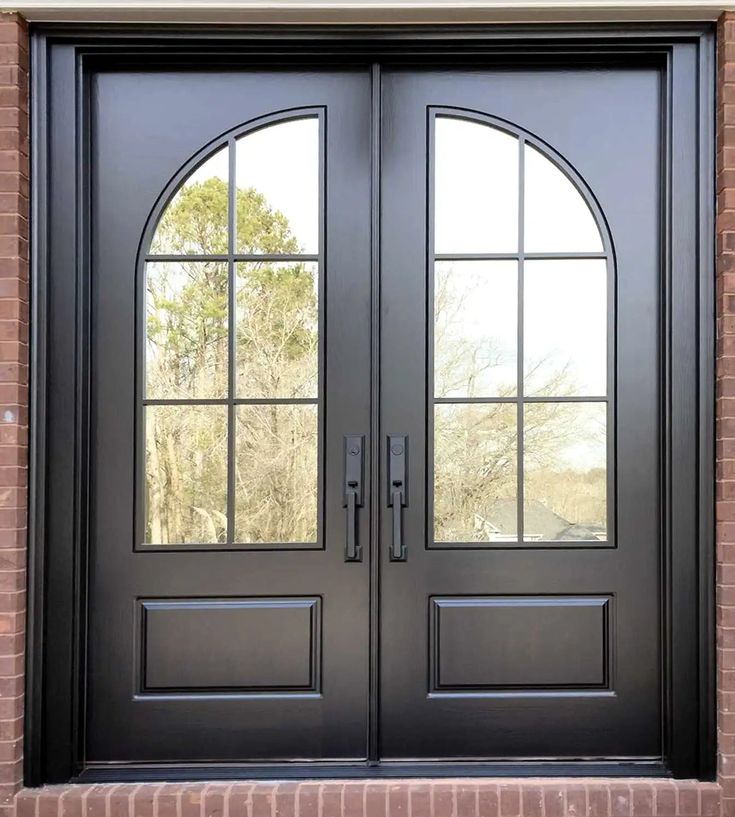 a black double door with arched glass