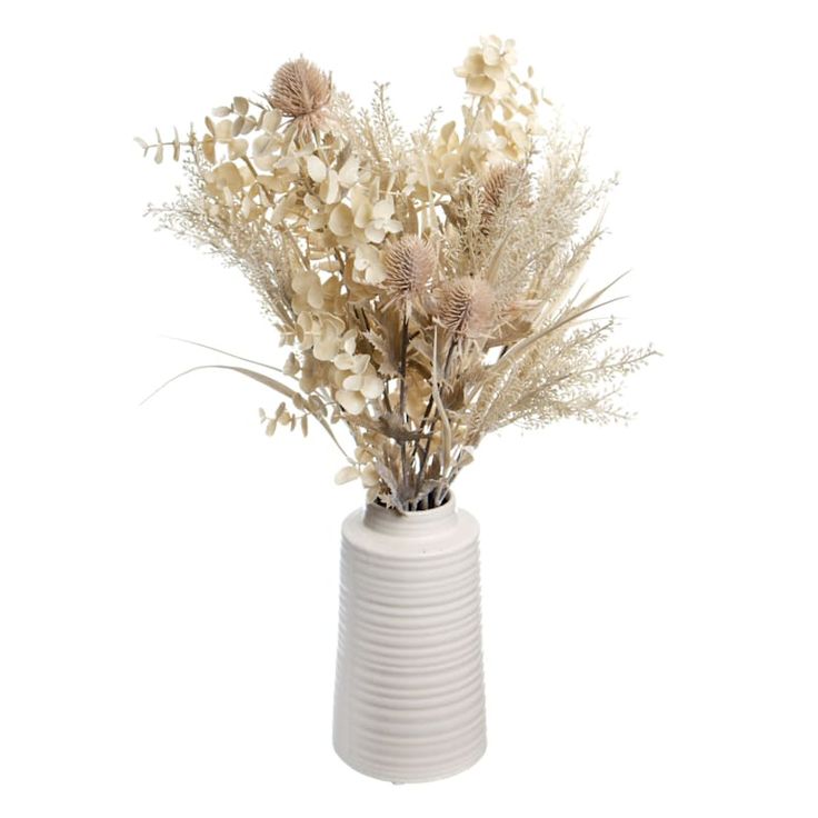 a white vase with dried flowers in it