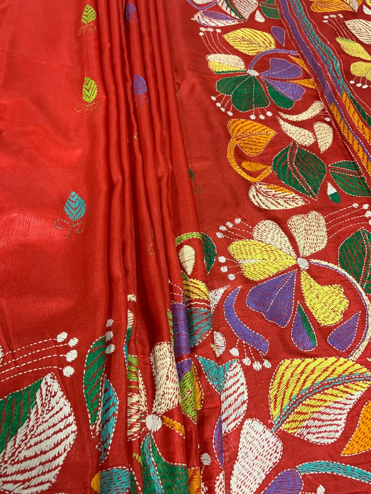 red and yellow fabric with colorful flowers on it