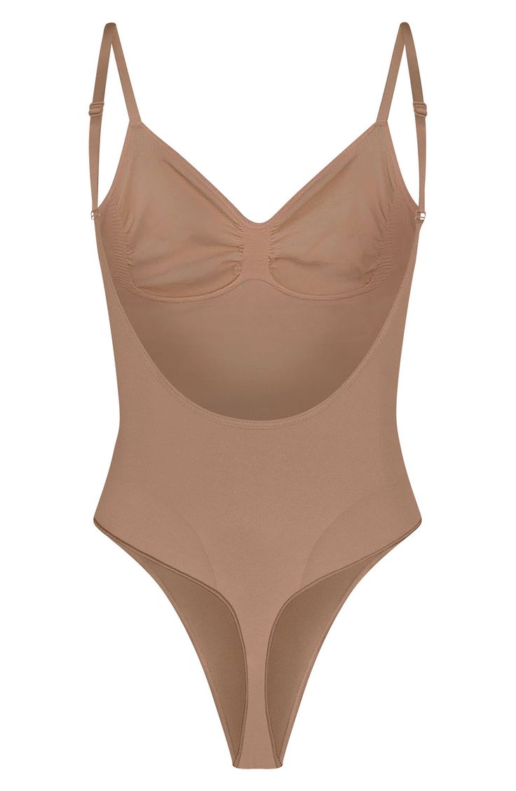 Sculpt your natural shape with a thong bodysuit that holds in your core and supports your chest flawlessly even in backless outfits. Sweetheart neck Adjustable straps 82% nylon, 18% spandex Machine wash, line dry Made in Turkey Sculpting Underwire Bodysuit With Built-in Bra, Sculpting Bodysuit With Built-in Bra And Underwire, Backless Nylon Leotard With Built-in Bra, High Cut Nylon Bodysuit With Built-in Bra, Sculpting Backless Swimwear With Built-in Bra, Shaping Backless Bodysuit With Built-in Bra, Backless Shapewear Leotard With Built-in Bra, Second-skin Bodysuit With Built-in Bra And Low Back, High Cut Leotard With Built-in Bra