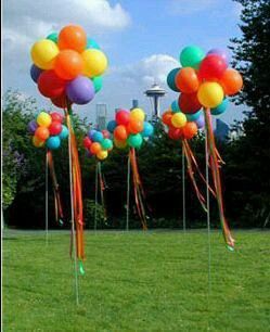 the princesses are standing in front of some balloons