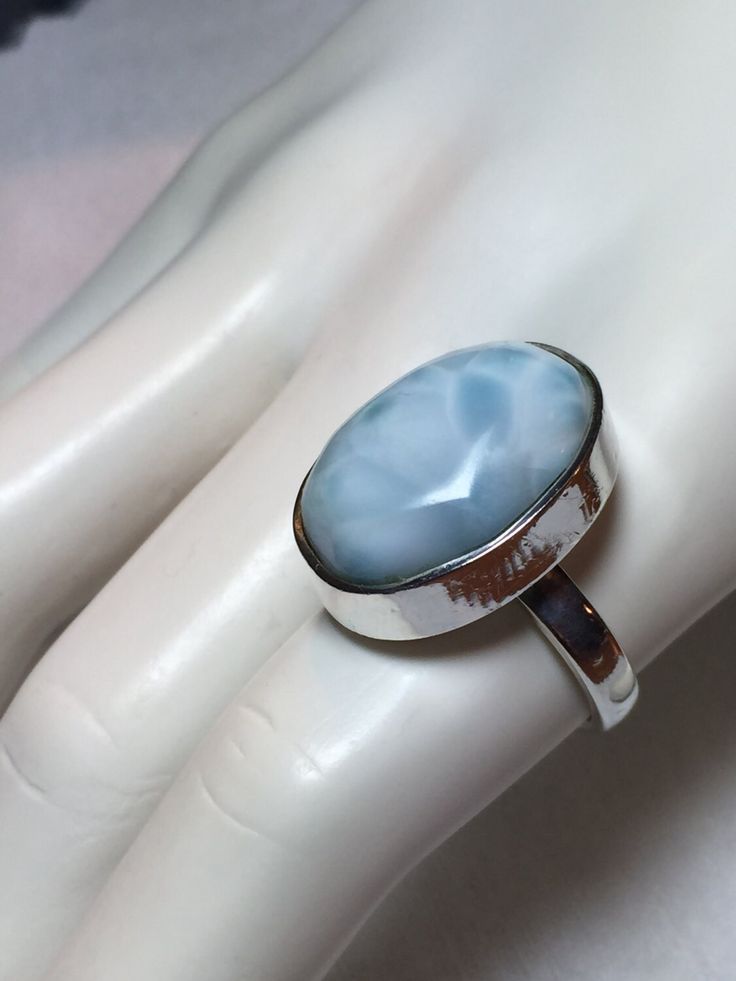 "Beautiful natural oval shape larimar stone sterling silver ring. This handmade ring arrives beautifully packaged in a gift box. Measurements: 22 mm x 12 mm Markings: 925  Larimar, or Stefilia's Stone, is a blue variety of pectolite found only in the Dominican Republic. \"Larimar is considered a healing stone. This ring is a size 8." Oval Polished Moonstone Ring Gift, Gift Turquoise Ring With Polished Finish, Oval Blue Larimar Jewelry, Larimar Turquoise Gemstone Ring For Anniversary, Hallmarked Larimar Jewelry, Oval Larimar Cabochon Rings, Larimar Cabochon Jewelry Gift, Elegant Turquoise Larimar Ring As Gift, Blue Larimar Round Rings