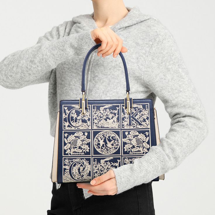 The Havilah Embroidery Medium Tote Bag is the perfect choice for a woman who wants something that is both stylish and functional. It has ample space for your necessities but will still look slim and stylish. The embroidery design adds a unique touch to show your great fashion sense. Now available in navy blue, claret, and beige. Embroidered Top Handle Bag For Daily Use, Embroidered Top Handle Shoulder Bag, Ladies' Floral Embroidery Top Handle Bag, Embroidered Double Handle Shoulder Bag For Shopping, Embroidered Blue Rectangular Shoulder Bag, Trendy Embroidered Rectangular Shoulder Bag, Rectangular Blue Embroidered Shoulder Bag, Embroidered Shoulder Bag For Shopping, Elegant Tote Bag With Floral Embroidery