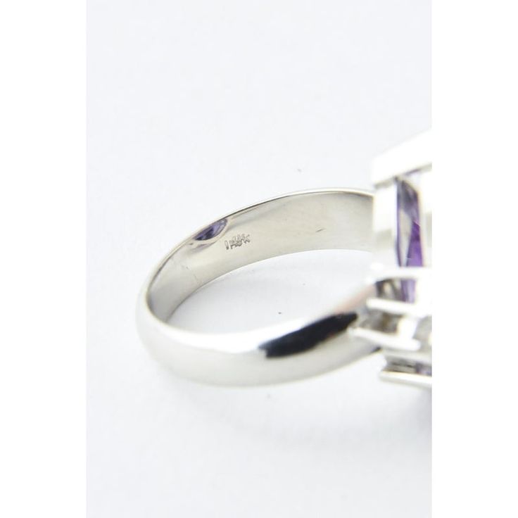 14K white gold ring presenting a faceted pear-shaped amethyst accented with three prong-set diamonds on each side. Amethyst, approximately 9 carats. Diamonds, .05 carats; G-H VS-SI. US size: 6 3/4; can be sized. Light age wear.  The ring measures .81" wide by .77" tall. Formal Ring With Trillion Cut And Accent Stones, Formal Rings With Accent Stones In Trillion Cut, Formal Trillion Cut Ring With Accent Stones, Modern Diamond Amethyst Ring, Modern Amethyst Diamond Ring, Formal Trillion-cut Sapphire Ring With Prong Setting, Luxury Silver Amethyst Ring With Prong Setting, Formal Trillion Cut Sapphire Ring With Prong Setting, Trillion Cut Platinum Gemstone Rings