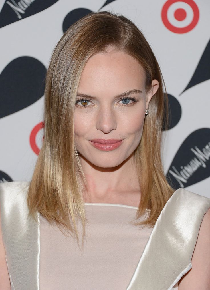 a woman with blonde hair and blue eyes wearing a white dress is posing for the camera