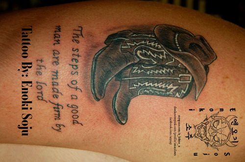 a tattoo on the back of a man's shoulder with an eagle and quote