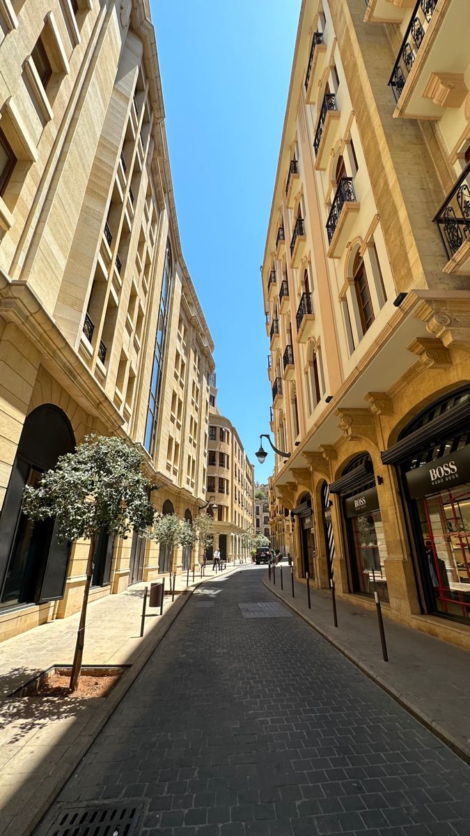 an empty city street lined with tall buildings