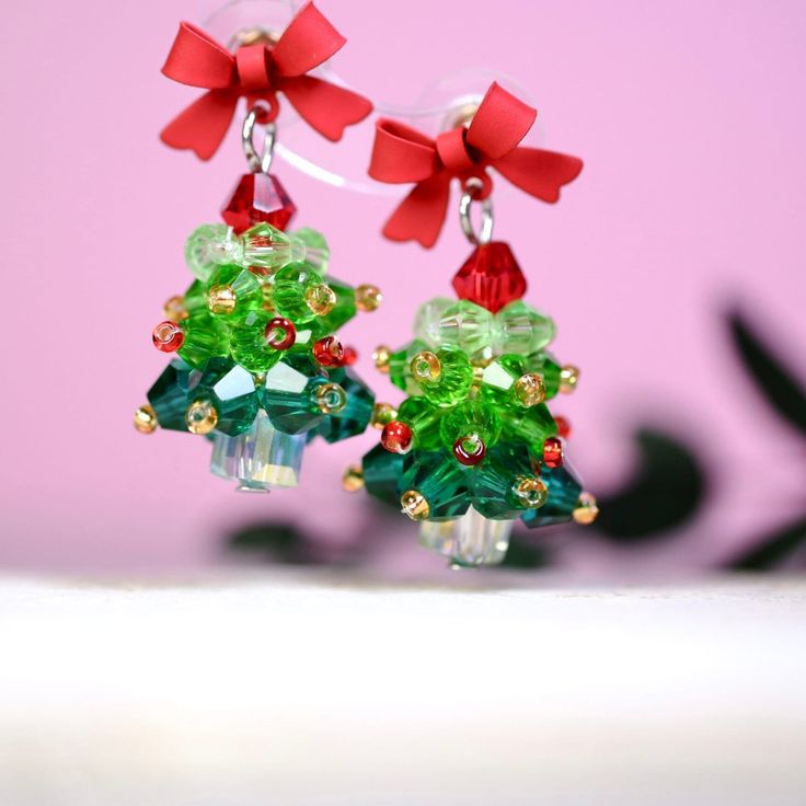 ♥ These earrings are made of high quality 14k gold filled sterling silver ♥ Get into the holiday spirit with our charming Christmas Tree Earrings! Handmade with love, these festive earrings feature a jolly Christmas tree made of green, red, and gold beads, topped with a cute red bow. Perfect for adding a touch of holiday magic to your look or gifting to someone special. ♥ Easy to wear and full of festive cheer, these earrings are a must-have accessory for the season. Make a statement at your nex Handmade Jewelry For Christmas Celebration, Christmas Jewelry Gift With Matching Earrings, Christmas Jewelry Gift Set With Matching Earrings, Christmas Jewelry Set As Gift With Matching Earrings, Dangle Earrings As Holiday Gifts, Holiday Dangle Earrings For Gifts, Holiday Gift Dangle Earrings, Christmas Celebration Jewelry With Matching Earrings, Dangle Earrings For Holiday Gift