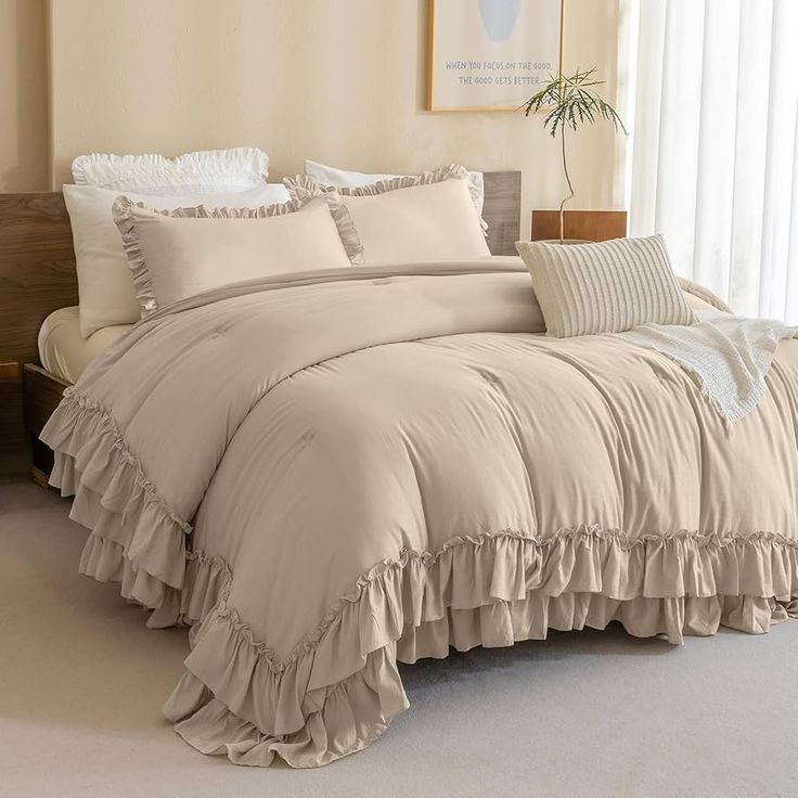 the comforter is made up with ruffles and pillows on top of it