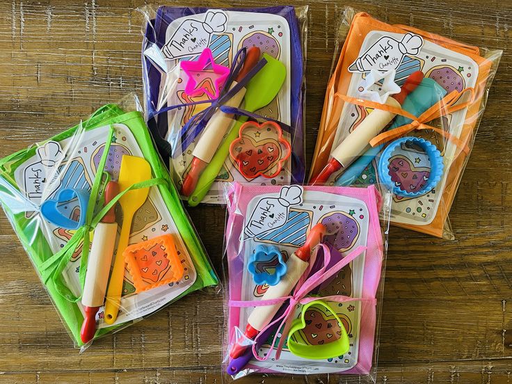 four bags filled with assorted craft items on top of a wooden table