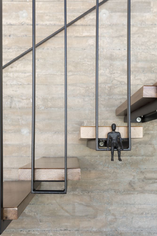 there is a small figurine sitting on the stair railing next to some stairs